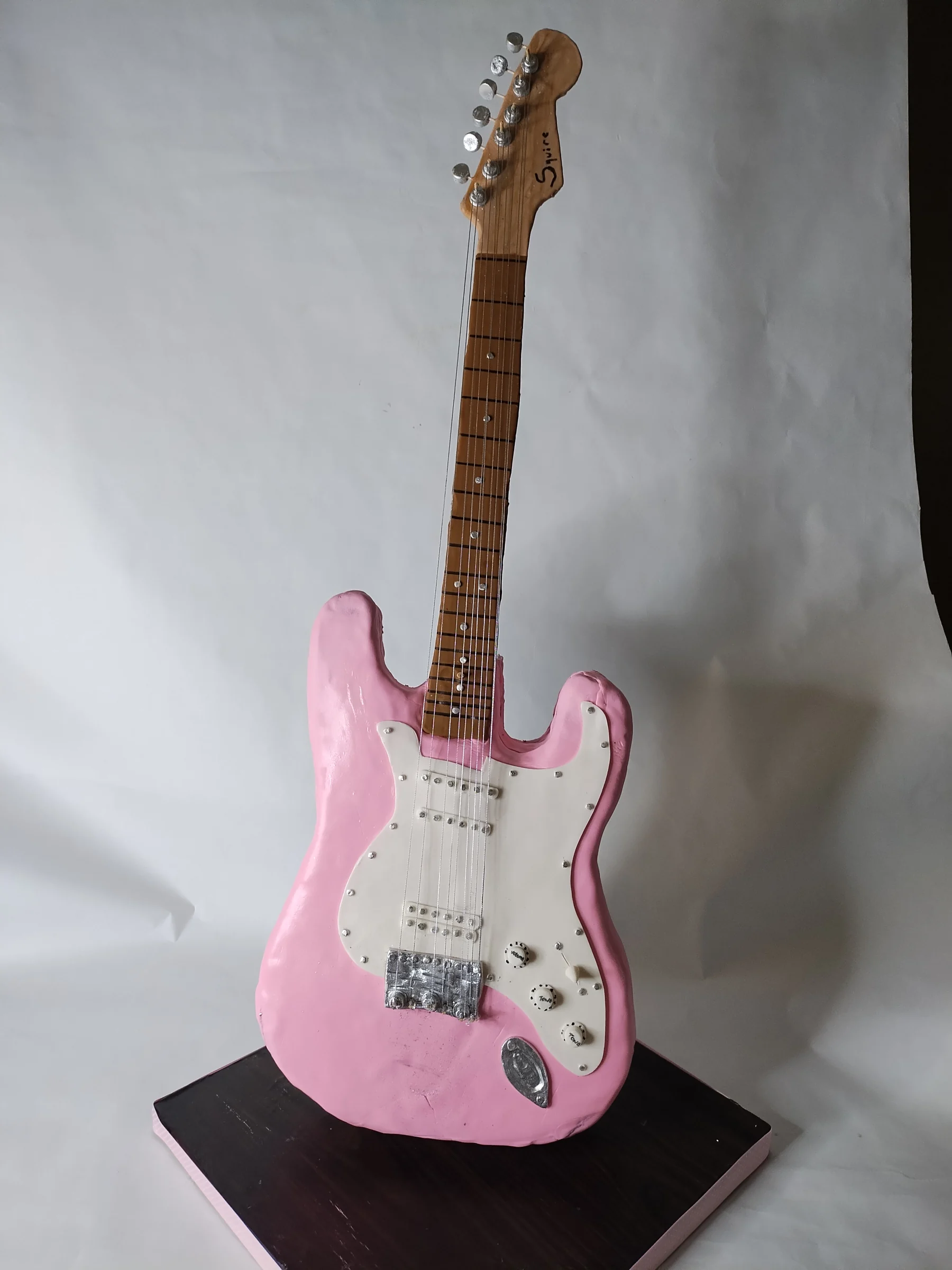 Pink guitar sculpted cake
